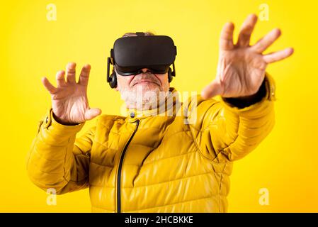 Man wearing futuristic helmet using laptop against red background Stock Photo