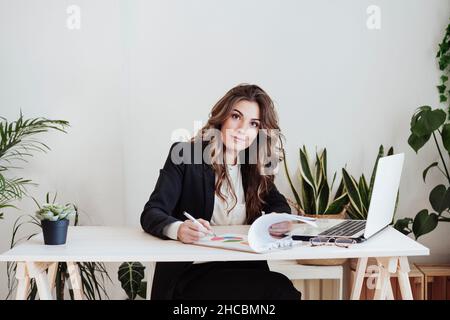Young businesswoman analyzing statistics at office Stock Photo