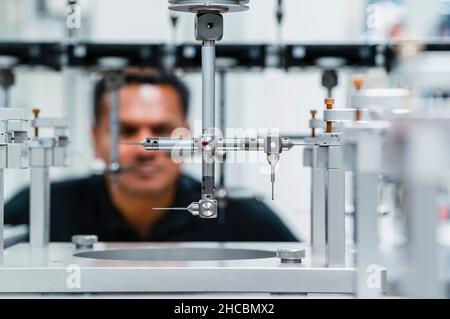 Engineer examining automated machine in industry Stock Photo