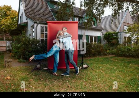 Smiling man sitting on stool at backyard Stock Photo