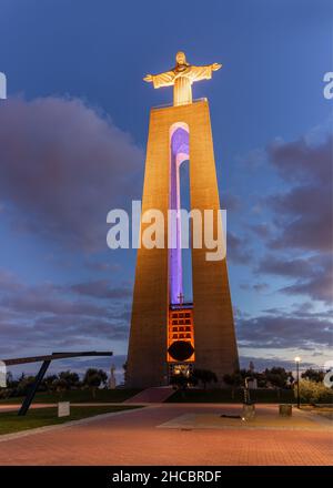 The statue of Christ the King stands in the district Almada and looks out over the Tagus River and the central part of Lisbon, Portugal. Stock Photo