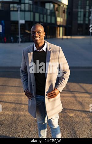 Smiling businessman leaning on railing Stock Photo