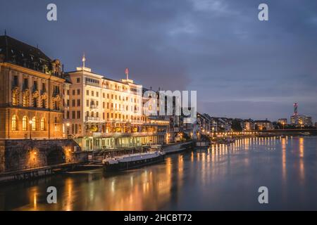 Switzerland, Basel-Stadt, Basel, City waterfront at night seen from Middle Bridge Stock Photo