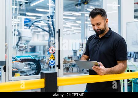 Maintenance engineer using tablet PC at electrical industry Stock Photo