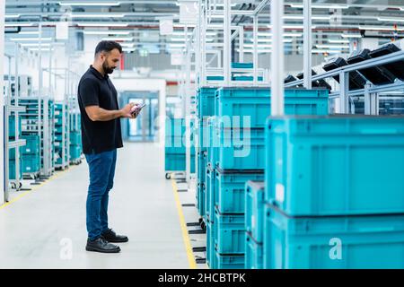 Maintenance engineer using tablet PC at warehouse Stock Photo