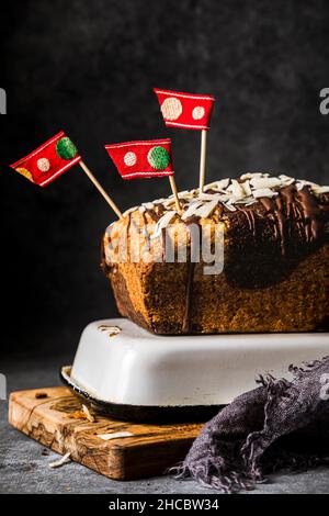 Sliced banana cake with walnuts and chocolate sauce on wax paper Stock Photo