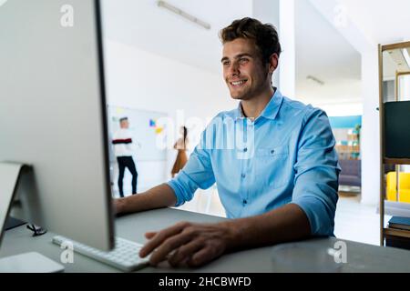 Happy coworkers working together in office Stock Photo