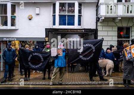 Lewes, UK. 27th Dec, 2021. A group of anti hunt protesters wait for the The Southdown and Eridge Hunt to arrive in Lewes High Street for their annual Boxing Day meeting, The event was switched this year to the 27th as Boxing Day fell on the Sunday. Credit: Grant Rooney/Alamy Live News Stock Photo