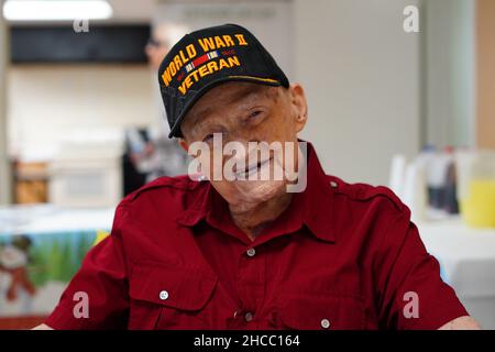 Tampa, USA. 19th Dec, 2021. Navy World War II veteran William E. Monfort, who turned 105 on Dec. 17, celebrates with members of his church on Sunday, Dec. 19, 2021 in Tampa, Florida. Monfort lived through the attack on Pearl Harbor and fighting in the Pacific during World War II as a member of the Navy. He recently survived a COVID-19 infection during the summer of 2020, before vaccines were available. (Photo by Luis Santana/Tampa Bay Times/TNS/Sipa USA) Credit: Sipa USA/Alamy Live News Stock Photo
