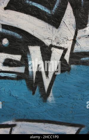 Hand painted graffiti with black and blue spray paint. Stock Photo