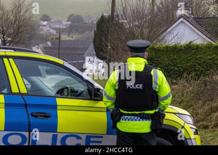 PSNI at the closed Radergan Road overlooking Kellys Inn on the Omagh Road area of Garvaghy after three men were killed at around 1.50am on Monday at the Omagh road area and involved a car and a lorry. Picture date: Monday December 27, 2021. Stock Photo