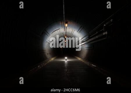 Long underground concrete corridor in a bunker tunnel Stock Photo