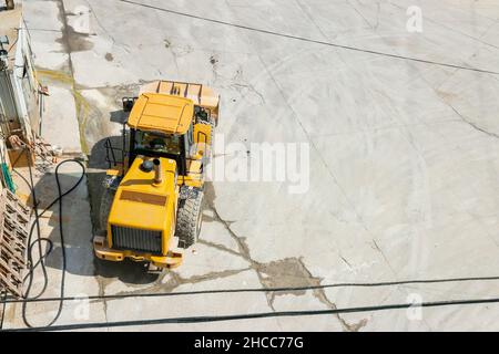 CAT Caterpillar wheeled loader  earth mover shot from above with copy space, on a construction site Stock Photo