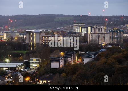 The skyline of Bristol city centre is lit at dusk, as viewed from Trooper's Hill. Stock Photo