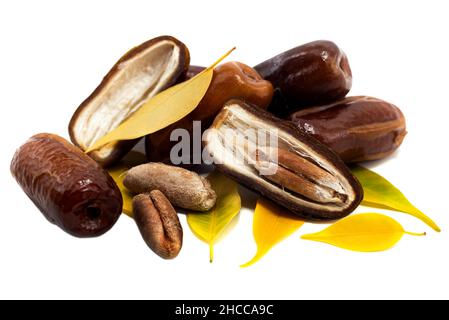 Dates on a white background. Dates isolate with seeds and leaves. Stock Photo