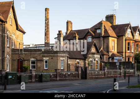 The old industrial chimney of Brewery Square rises above houses in Dorchester, Dorset. Stock Photo