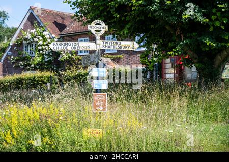 A traditional English 'fingerpost' directions sign stands in the village of Bedchester, Dorset. Stock Photo