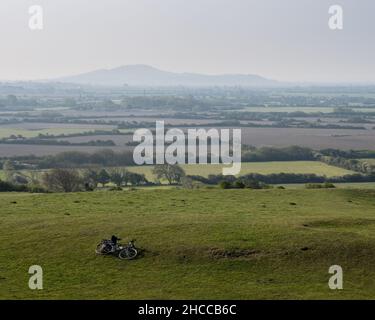Morning mists rise from the fields of Bleadon Level, with Brent Knoll in the background, on England's Somerset Levels. Stock Photo