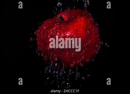 Red apple with water drops on black background Stock Photo