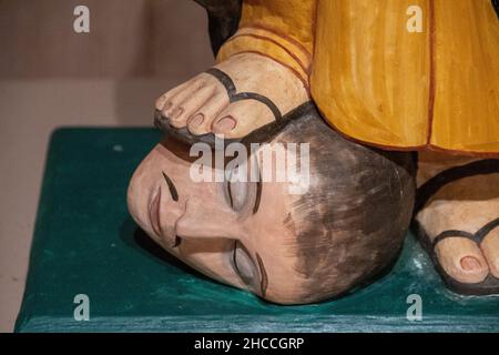 A small statue of a friar stands on a head Stock Photo