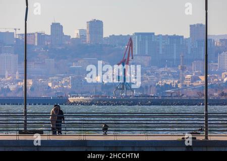 Baku, Azerbaijan - Desember 25, 2021: Fishermen catch fish on the boulevard in Baku Stock Photo