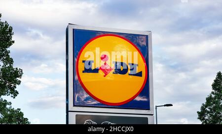 Roses, Spain - September 13, 2021. Lidl brand logo sign against cloudy sky. Lidl is a popular German supermarket chain of stores operating across Euro