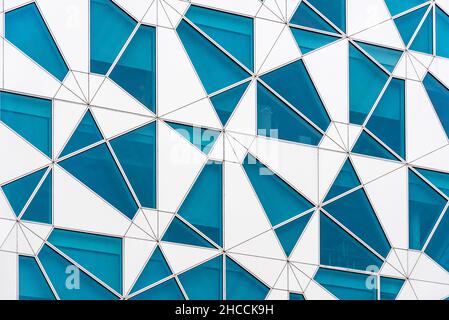 Oslo, Norway - August 11, 2019: Futuristic abstract facade of office building with irregular pieces of blue colored glass and aluminum. Barcode Projec Stock Photo