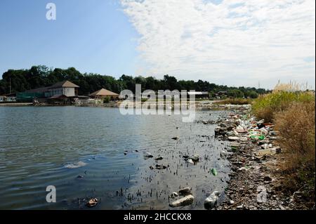 The lake and the shore are littered with the garbage Stock Photo