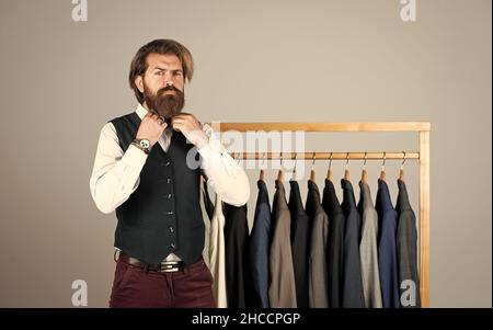 Man picking suit from personal wardrobe, male fashion concept Stock Photo