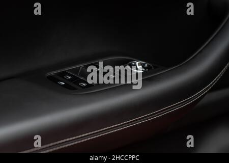 Side mirrors control panel on side door. Car driver adjust side mirror controller. Side mirror control button for adjusting the side mirrors. Stock Photo