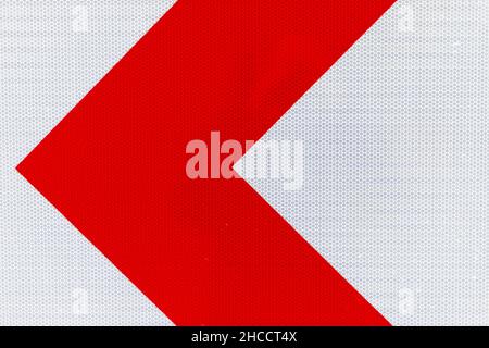 Left turn direction, red and white road sign mounted on roadside, close up photo Stock Photo