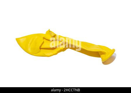 Popped yellow balloon isolated on white background Stock Photo