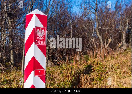 Polish, white and red border post. On the pole, there is a white eagle with a golden crown and the inscription Polska - Poland. Stock Photo