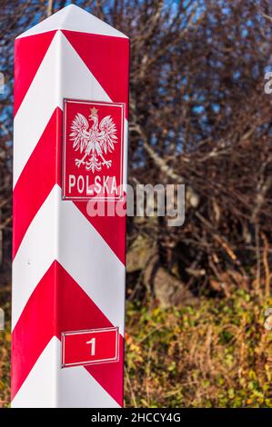 Polish, white and red border post. On the pole, there is a white eagle with a golden crown and the inscription Polska - Poland. Stock Photo