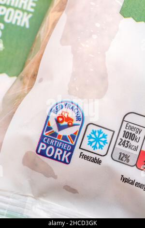 Red Tractor label on packet of ASDA supermarket own-label Lincolnshire sausages. For dietary information labeling, plastic packaging, freezer symbol. Stock Photo