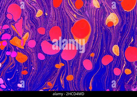 Colorful paper marbling texture with bright pink spots in the purple background Stock Photo
