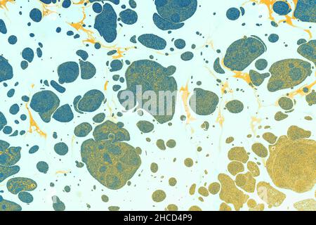 Colorful paper marbling texture with chaotic spots in the light blue background Stock Photo