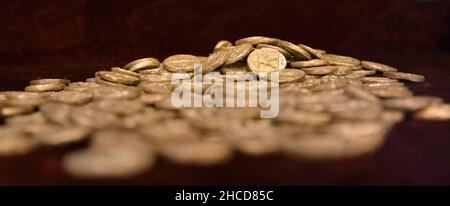 Treasury of ancient Greek coins on dark background Stock Photo
