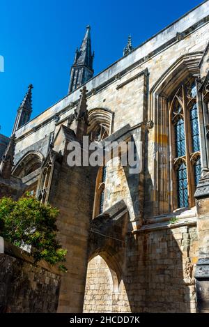 The historic buttresses,with their arched passageways,support either side of the Cathedral,here under blue skies,on a warm summer afternoon. Stock Photo