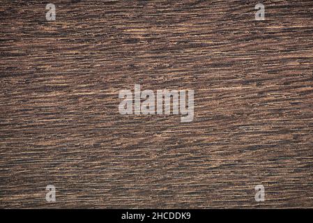 Dark walnut, deep brown natural wood grain close-up. Background, pattern, texture. Stock Photo