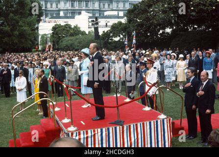 United States President Gerald R. Ford, left, salutes as he hosts an arrival ceremony in honor of Queen Elizabeth II of Great Britain, right, at the White House in Washington, DC on July 7, 1976.  The Queen is in Washington for a State Visit. Credit: Barry A. Soorenko / CNP /MediaPunch Stock Photo