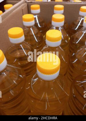 Vegetable oil in plastic bottles in a box. Selling vegetable oil in a market or store. Stock Photo