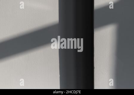Empty room interior fragment with shadows pattern on gray wall. Abstract background photo texture Stock Photo