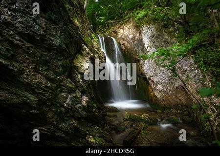 The Devil’s Mill waterfall encountered during a hike through Tasnei gorges. Photo taken on 29th of May 2021, near Heculane, in the National Park Domog Stock Photo