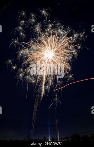 Closeup of fireworks exploding in mid-air during the night Stock Photo