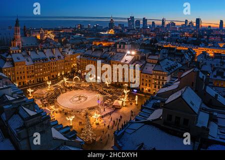 Warsaw, old town market decorated with christmas lights and city center winter aerial panorama at dusk Stock Photo