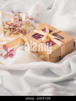 Eco-friendly gift packaging made of kraft paper. Eco style holiday concept. Selective focus. Valentines day, mother'day Stock Photo
