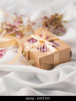 Eco-friendly gift packaging made of kraft paper. Eco style holiday concept. Selective focus. Valentines day, mother'day Stock Photo