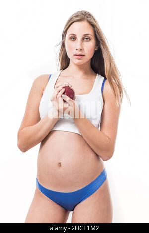 Healthy Lifestyle - fitness model eats an apple after a workout Stock Photo