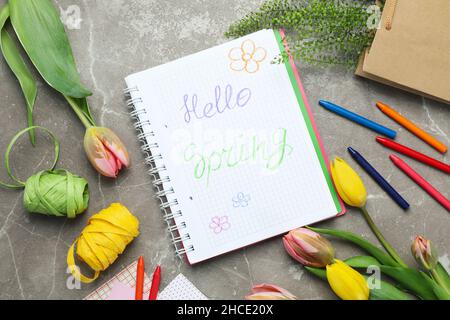 Hello spring concept on gray textured background Stock Photo